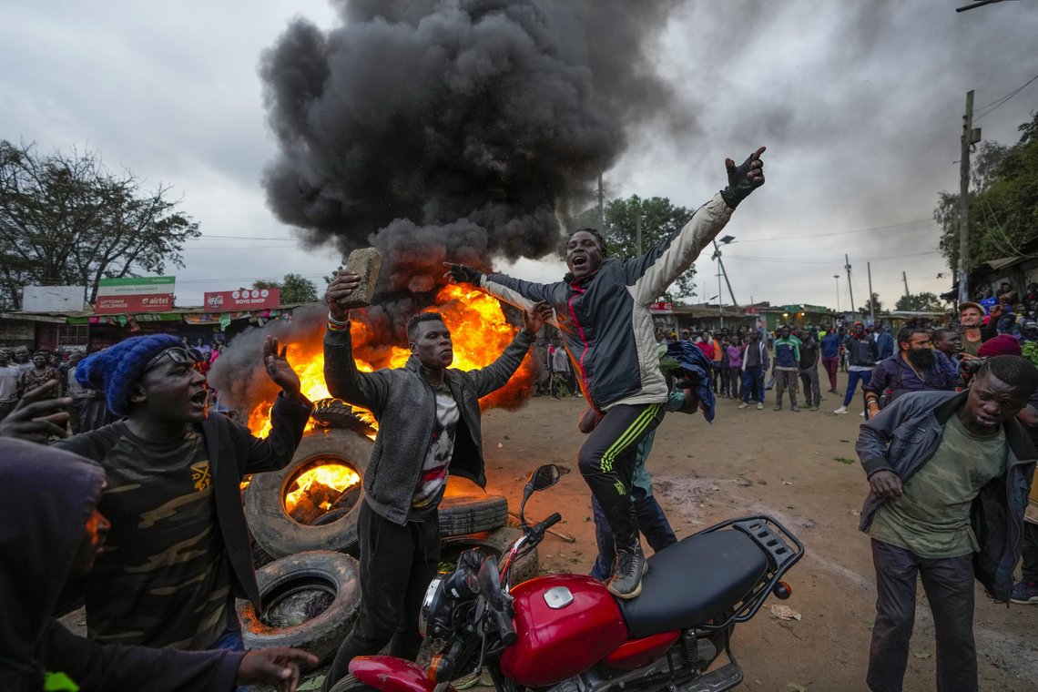Shouting "No Raila No Peace," Kenyan opposition leader Raila Odinga supporters burn tyres in the Kibera neighborhood of Nairobi, Kenya, Monday, Aug. 15, 2022. Kenya’s electoral commission chairman has declared Deputy President William Ruto the winner of the close presidential election over five-time contender Raila Odinga, a triumph for the man who shook up politics by appealing to struggling Kenyans on economic terms and not on traditional ethnic ones. (AP Photo/Ben Curtis) Shouting "No Raila No Peace," Kenyan opposition leader Raila Odinga supporters burn tyres in the Kibera neighborhood of Nairobi, Kenya, Monday, Aug. 15, 2022. Kenya’s electoral commission chairman has declared Deputy President William Ruto the winner of the close presidential election over five-time contender Raila Odinga, a triumph for the man who shook up politics by appealing to struggling Kenyans on economic terms and not on traditional ethnic ones. (AP Photo/Ben Curtis)