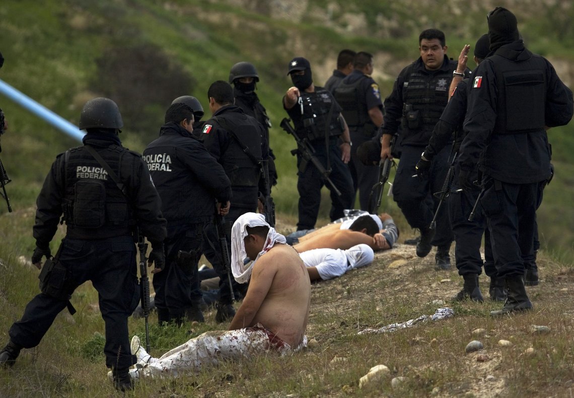 Federal police officers stand over suspects taken into custody in connection with a shooting in Tijuana, Mexico, Monday, March 9, 2009. Mexico's cartels are losing their grip on the prized U.S. drug market, largely because of a cross-border crackdown and a regional shift in worldwide cocaine consumption.(AP Photo/Guillermo Arias) Federal police officers stand over suspects taken into custody in connection with a shooting in Tijuana, Mexico, Monday, March 9, 2009. Mexico's cartels are losing their grip on the prized U.S. drug market, largely because of a cross-border crackdown and a regional shift in worldwide cocaine consumption.(AP Photo/Guillermo Arias)