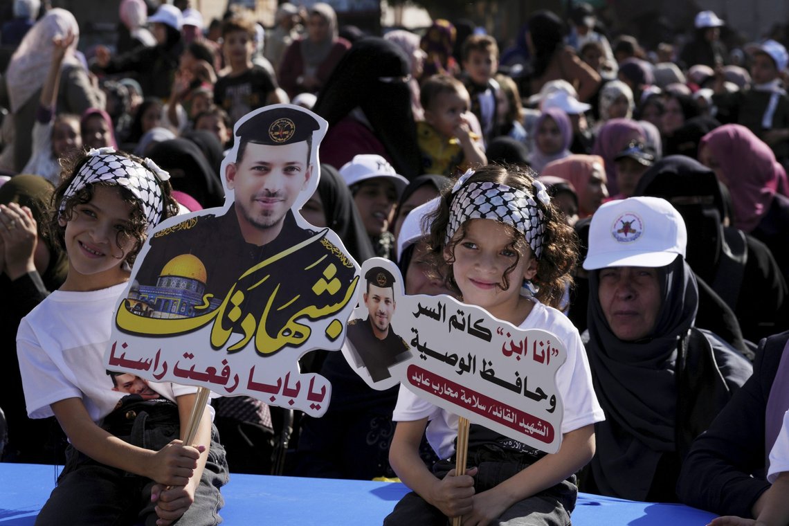 Children hold photos of their relative, Salama Abed, who was killed during the last war on Gaza, during an anti-Israel rally called, 'the way to Jerusalem, the battle of the unity of areas,' on the main road of the Shijaiyah neighborhood in Gaza City, Thursday, Aug. 25, 2022. Arabic reads, "I'm the son of the silencer and the keeper of the will, with your martyr you raised our heads." (AP Photo/Adel Hana) Children hold photos of their relative, Salama Abed, who was killed during the last war on Gaza, during an anti-Israel rally called, 'the way to Jerusalem, the battle of the unity of areas,' on the main road of the Shijaiyah neighborhood in Gaza City, Thursday, Aug. 25, 2022. Arabic reads, "I'm the son of the silencer and the keeper of the will, with your martyr you raised our heads." (AP Photo/Adel Hana)