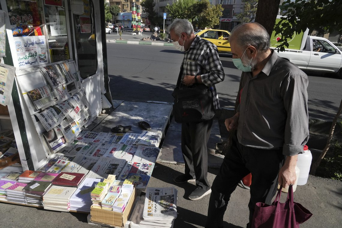 Iranere kikker på aviser i hovedstaden Teheran lørdag. Flere iranske aviser hyller angrepet på Salman Rushdie. Foto: Vahid Salemi / AP / NTB Iranere kikker på aviser i hovedstaden Teheran lørdag. Flere iranske aviser hyller angrepet på Salman Rushdie. Foto: Vahid Salemi / AP / NTB
