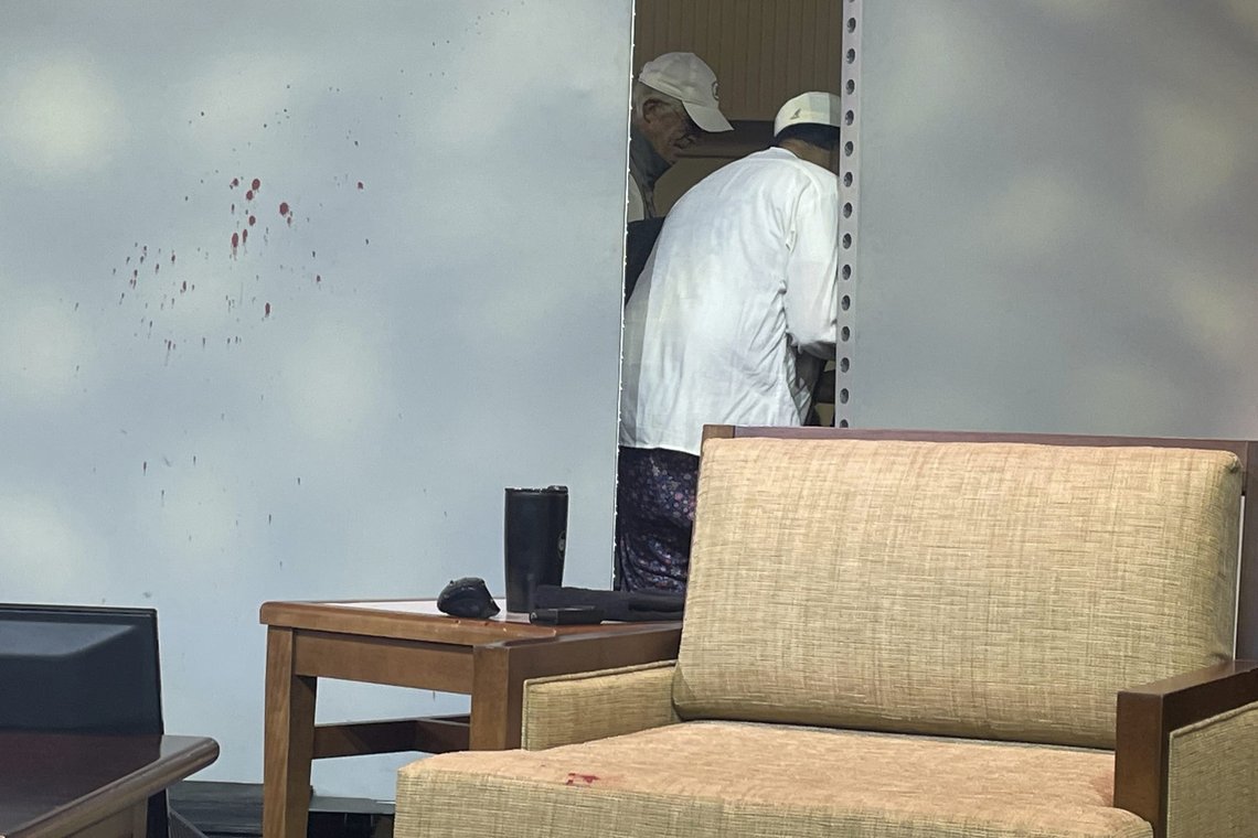 Blood stains mark a screen as author Salman Rushdie, behind screen, is tended to after he was attacked during a lecture, Friday, Aug. 12, 2022, at the Chautauqua Institution in Chautauqua, N.Y., about 75 miles (120 km) south of Buffalo. (AP Photo/Joshua Goodman) Blood stains mark a screen as author Salman Rushdie, behind screen, is tended to after he was attacked during a lecture, Friday, Aug. 12, 2022, at the Chautauqua Institution in Chautauqua, N.Y., about 75 miles (120 km) south of Buffalo. (AP Photo/Joshua Goodman)