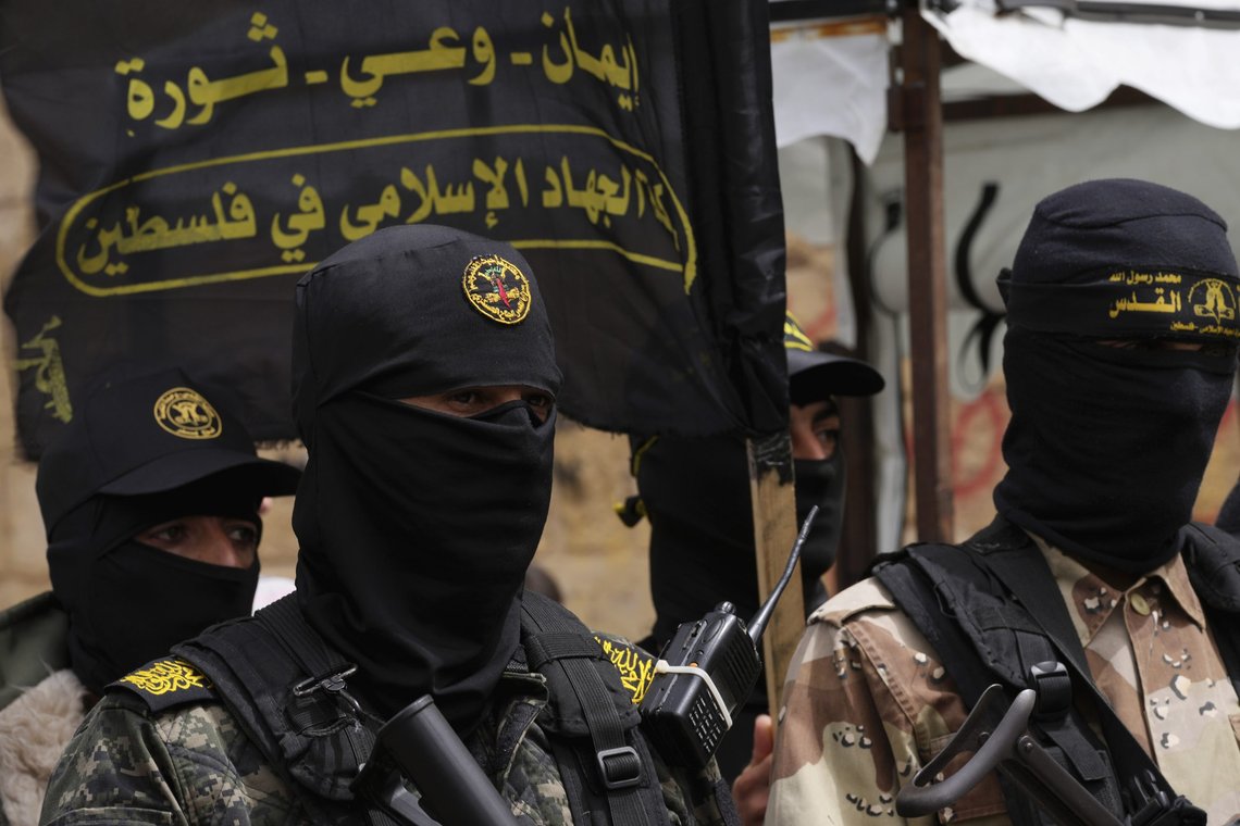 Masked members of the Al-Quds Brigades, the military wing of the Islamic Jihad group, take part in a rally celebrating the last night shooting rampage in Israel in which a Palestinian attacker killed two Israelis after Friday prayer, outside the main mosque in Khan Younis City, southern Gaza Strip, Friday, April 8, 2022. (AP Photo/Adel Hana) Masked members of the Al-Quds Brigades, the military wing of the Islamic Jihad group, take part in a rally celebrating the last night shooting rampage in Israel in which a Palestinian attacker killed two Israelis after Friday prayer, outside the main mosque in Khan Younis City, southern Gaza Strip, Friday, April 8, 2022. (AP Photo/Adel Hana)
