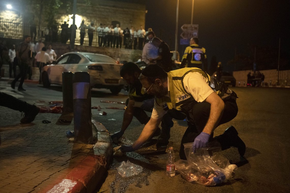 Volunteers with Zaka rescue service clean blood from the scene of a shooting attack that wounded several Israelis near the Old City of Jerusalem, early Sunday, Aug. 14, 2022. Israeli police and medics say a gunman opened fire at a bus in a suspected Palestinian attack that came a week after violence flared up between Israel and militants in Gaza. (AP Photo/ Maya Alleruzzo) Volunteers with Zaka rescue service clean blood from the scene of a shooting attack that wounded several Israelis near the Old City of Jerusalem, early Sunday, Aug. 14, 2022. Israeli police and medics say a gunman opened fire at a bus in a suspected Palestinian attack that came a week after violence flared up between Israel and militants in Gaza. (AP Photo/ Maya Alleruzzo)