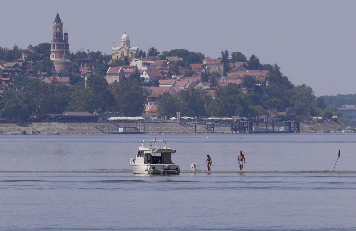 People with a dog cool off on the sandbank on the confluence of the Sava and the Danube rivers, in Belgrade, Serbia, Monday, Aug. 15, 2022. Water levels are falling on major rivers such as the Danube, the Rhine and the Po. (AP Photo/Darko Vojinovic) People with a dog cool off on the sandbank on the confluence of the Sava and the Danube rivers, in Belgrade, Serbia, Monday, Aug. 15, 2022. Water levels are falling on major rivers such as the Danube, the Rhine and the Po. (AP Photo/Darko Vojinovic)