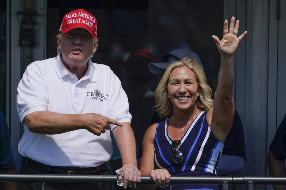 FILE - Rep. Marjorie Taylor Greene, R-Ga., waves while former President Donald Trump points to her while they look over the 16th tee during the second round of the Bedminster Invitational LIV Golf tournament in Bedminster, N.J., July 30, 2022. Republicans ranging from Senate Minority Leader Mitch McConnell to Marjorie Taylor Greene defended Trump against an unprecedented FBI search. (AP Photo/Seth Wenig, File) FILE - Rep. Marjorie Taylor Greene, R-Ga., waves while former President Donald Trump points to her while they look over the 16th tee during the second round of the Bedminster Invitational LIV Golf tournament in Bedminster, N.J., July 30, 2022. Republicans ranging from Senate Minority Leader Mitch McConnell to Marjorie Taylor Greene defended Trump against an unprecedented FBI search. (AP Photo/Seth Wenig, File)
