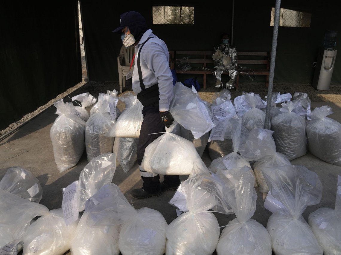 A city employee carries a bag of seized cocaine to be destroyed at a police base in Lima, Peru, Monday, April 18, 2022. Police say they will destroy about 16 tons of drugs seized over the past four months, including cocaine, marijuana, opium and ecstasy. (AP Photo/Martin Mejia) A city employee carries a bag of seized cocaine to be destroyed at a police base in Lima, Peru, Monday, April 18, 2022. Police say they will destroy about 16 tons of drugs seized over the past four months, including cocaine, marijuana, opium and ecstasy. (AP Photo/Martin Mejia)