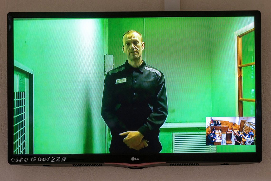 Russian opposition leader Alexei Navalny is seen on a TV screen, as he appears in a video link from prison provided by the Russian Federal Penitentiary Service in a courtroom in Kovrov, 240 km (150 miles) north-east of Moscow, Russia, Friday, Sept. 2, 2022. Russian President Vladimir Putin's fiercest foe, was sentenced to nine years in prison on charges of fraud and contempt of court, allegations he rejected as a politically motivated attempt by Russian authorities to keep him behind bars for as long as possible. (AP Photo) Russian opposition leader Alexei Navalny is seen on a TV screen, as he appears in a video link from prison provided by the Russian Federal Penitentiary Service in a courtroom in Kovrov, 240 km (150 miles) north-east of Moscow, Russia, Friday, Sept. 2, 2022. Russian President Vladimir Putin's fiercest foe, was sentenced to nine years in prison on charges of fraud and contempt of court, allegations he rejected as a politically motivated attempt by Russian authorities to keep him behind bars for as long as possible. (AP Photo)