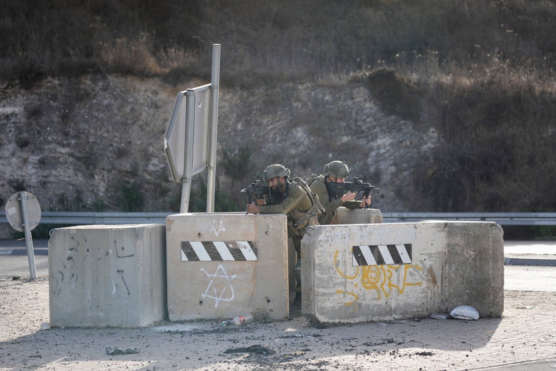 Israeli soldiers take position at a roadblock near the West Bank town of Nablus, Saturday, Sept. 24 2022. Israeli troops on Saturday shot and killed a Palestinian motorist who allegedly tried to ram his car into a group of soldiers patrolling in the occupied West Bank, according to Israeli soldiers and media. (AP Photo/Majdi Mohammed) Israeli soldiers take position at a roadblock near the West Bank town of Nablus, Saturday, Sept. 24 2022. Israeli troops on Saturday shot and killed a Palestinian motorist who allegedly tried to ram his car into a group of soldiers patrolling in the occupied West Bank, according to Israeli soldiers and media. (AP Photo/Majdi Mohammed)