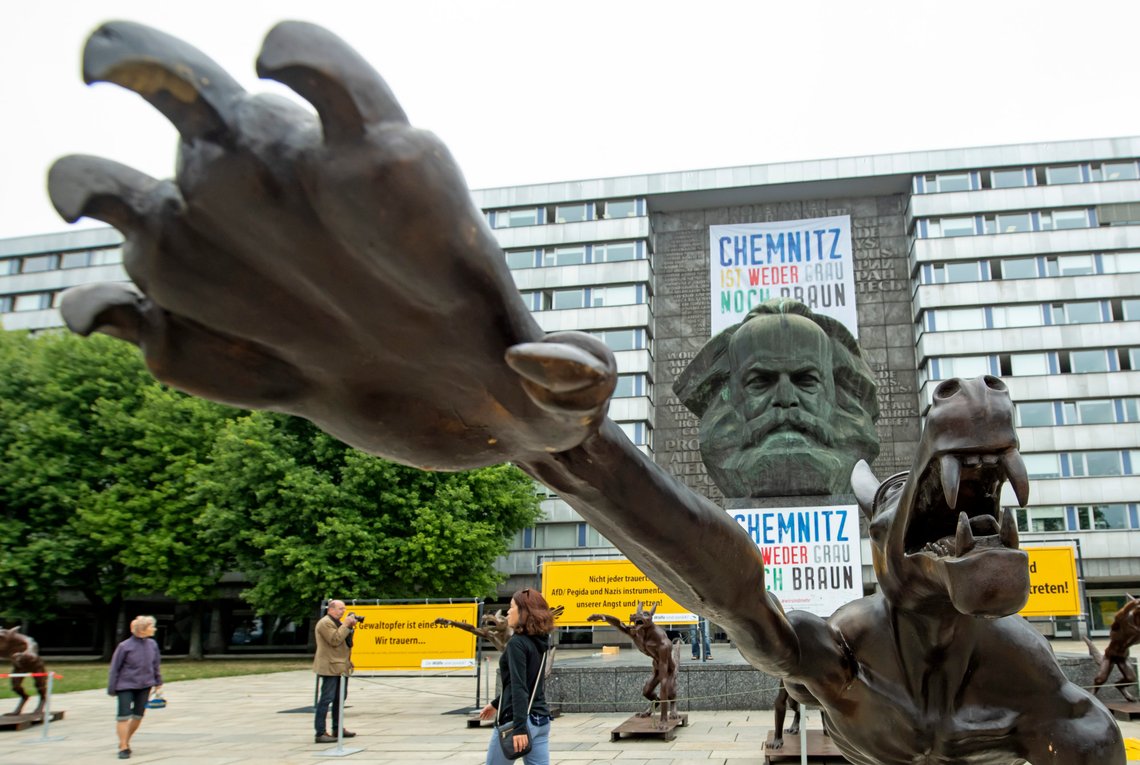 People walk between sculptures by artist Rainer Opolka in front of the Karl Marx Monument in Chemnitz, eastern Germany, Thursday, Sept. 13, 2018. The figure in the foreground is one of 10 life-sized metal wolf sculptures as a part of the spontan exhibition 'Wolves with Hitler salute howl in front of the Karl-Marx-Monument', to protest against xenophobia and right-wing extremism. (AP Photo/Jens Meyer) People walk between sculptures by artist Rainer Opolka in front of the Karl Marx Monument in Chemnitz, eastern Germany, Thursday, Sept. 13, 2018. The figure in the foreground is one of 10 life-sized metal wolf sculptures as a part of the spontan exhibition 'Wolves with Hitler salute howl in front of the Karl-Marx-Monument', to protest against xenophobia and right-wing extremism. (AP Photo/Jens Meyer)