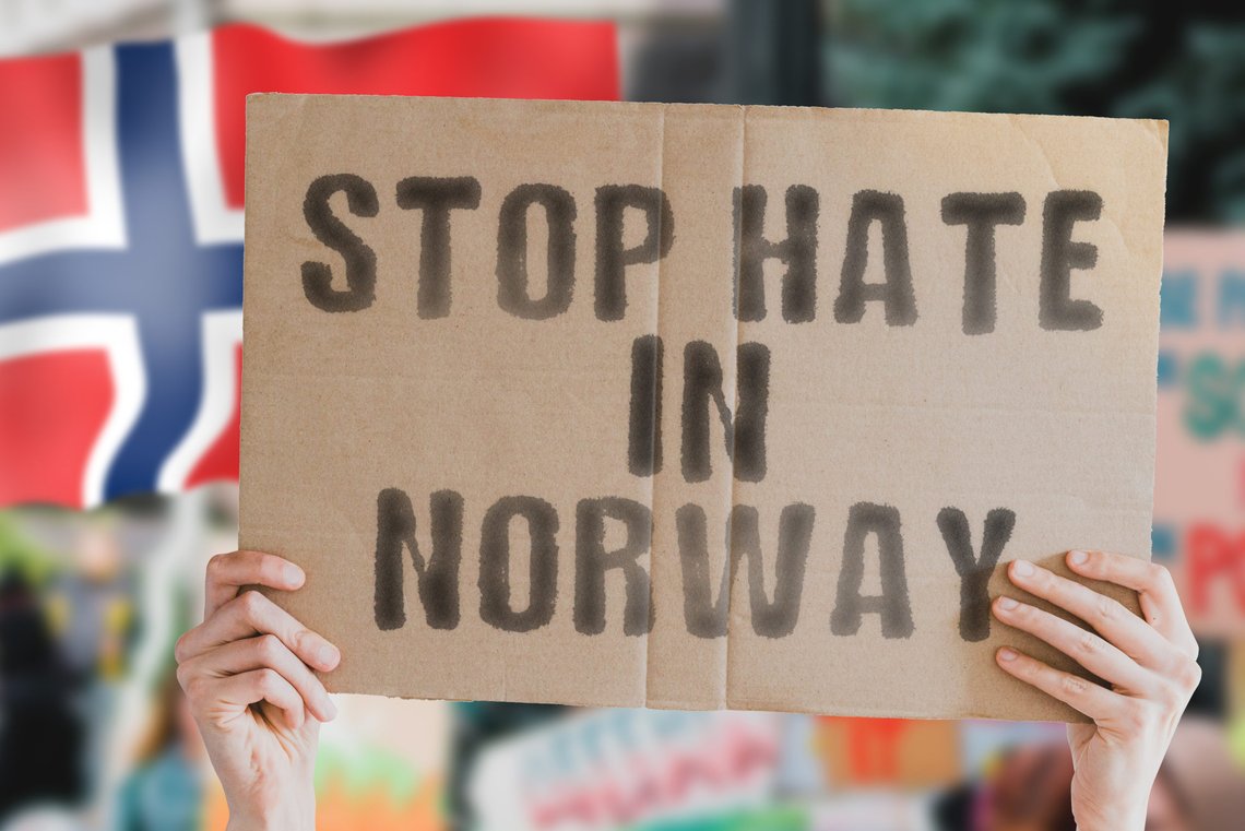 Shutterstock: The phrase " Stop hate in Norway " on a banner in men's hand with blurred Norwegian flag on the background. Gay. Human rights. Equality. Social issues. Society. Problem. Conflict. Contributor: AndriiKoval, USA. Shutterstock: The phrase " Stop hate in Norway " on a banner in men's hand with blurred Norwegian flag on the background. Gay. Human rights. Equality. Social issues. Society. Problem. Conflict. Contributor: AndriiKoval, USA.