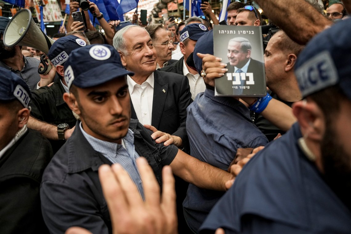 Likud party head and former Israeli Prime Minister Benjamin Netanyahu, center, surrounded by security and his supporters visits at Hatikva Market in Tel Aviv, Israel, Friday, Oct. 28, 2022, during his campaign ahead of the country's election. Israel is heading into its fifth election in under four years on Nov. 1, 2022. (AP Photo/Ariel Schalit) Likud party head and former Israeli Prime Minister Benjamin Netanyahu, center, surrounded by security and his supporters visits at Hatikva Market in Tel Aviv, Israel, Friday, Oct. 28, 2022, during his campaign ahead of the country's election. Israel is heading into its fifth election in under four years on Nov. 1, 2022. (AP Photo/Ariel Schalit)