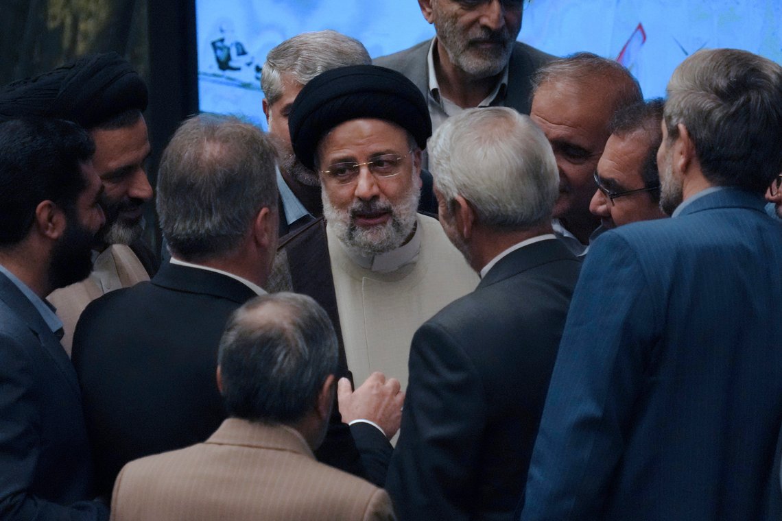 Iranian President Ebrahim Raisi is surrounded by a group of lawmakers after defending his proposed labor minister in a vote of confidence session at the parliament in Tehran, Iran, Tuesday, Oct. 4, 2022. (AP Photo/Vahid Salemi) Iranian President Ebrahim Raisi is surrounded by a group of lawmakers after defending his proposed labor minister in a vote of confidence session at the parliament in Tehran, Iran, Tuesday, Oct. 4, 2022. (AP Photo/Vahid Salemi)