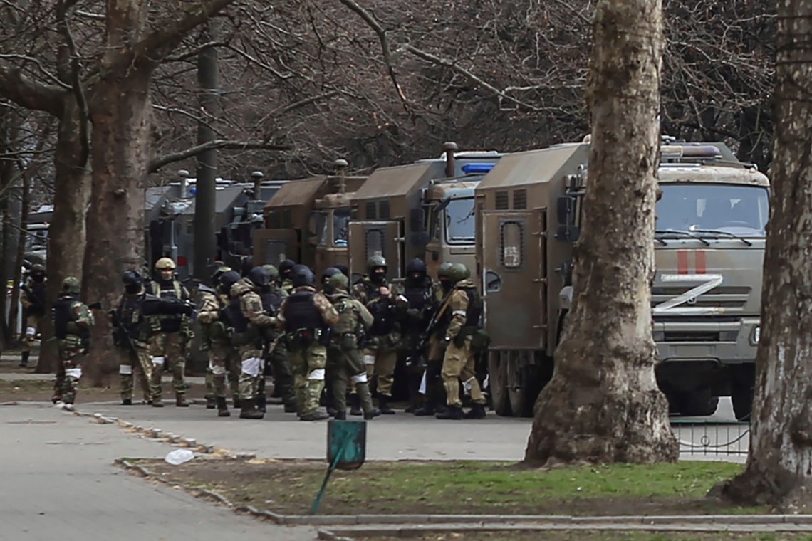 FILE - Russian army soldiers stand next to their trucks during a rally against Russian occupation in Svobody (Freedom) Square in Kherson, Ukraine, on March 7, 2022. As Russian forces sought to tighten their hold on Melitopol, hundreds of residents took to the streets to demand the mayor's release. (AP Photo/Olexandr Chornyi, File) FILE - Russian army soldiers stand next to their trucks during a rally against Russian occupation in Svobody (Freedom) Square in Kherson, Ukraine, on March 7, 2022. As Russian forces sought to tighten their hold on Melitopol, hundreds of residents took to the streets to demand the mayor's release. (AP Photo/Olexandr Chornyi, File)