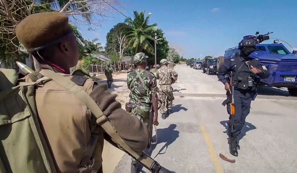 In this image made from video, a Rwandan policeman, right, and Mozambican military, left, patrol near the Amarula Palma hotel in Palma, Cabo Delgado province, Mozambique Sunday, Aug. 15, 2021. Rwanda's troops have rapidly helped Mozambique's armed forces achieve victories against Islamic extremists, who have created a humanitarian emergency in northern Cabo Delgado province and surrounding areas. (AP Photo/Marc Hoogsteyns) In this image made from video, a Rwandan policeman, right, and Mozambican military, left, patrol near the Amarula Palma hotel in Palma, Cabo Delgado province, Mozambique Sunday, Aug. 15, 2021. Rwanda's troops have rapidly helped Mozambique's armed forces achieve victories against Islamic extremists, who have created a humanitarian emergency in northern Cabo Delgado province and surrounding areas. (AP Photo/Marc Hoogsteyns)