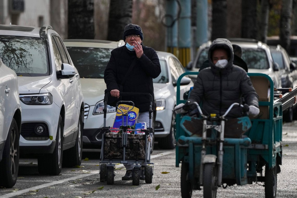 A man smokes while pushing a trolley loaded with groceries on a quiet street in Beijing, Tuesday, Nov. 29, 2022. Chinese universities are sending students home as the ruling Communist Party tightens anti-virus controls and tries to prevent more protests after crowds angered by its severe "zero COVID" restrictions called for President Xi Jinping to resign in the biggest show of public dissent in decades. (AP Photo/Andy Wong) A man smokes while pushing a trolley loaded with groceries on a quiet street in Beijing, Tuesday, Nov. 29, 2022. Chinese universities are sending students home as the ruling Communist Party tightens anti-virus controls and tries to prevent more protests after crowds angered by its severe "zero COVID" restrictions called for President Xi Jinping to resign in the biggest show of public dissent in decades. (AP Photo/Andy Wong)