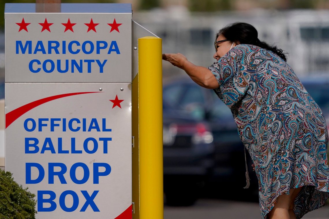 A voter drops off her ballot at a drop box, Monday, Nov. 7, 2022, in Mesa, Ariz. (AP Photo/Matt York) A voter drops off her ballot at a drop box, Monday, Nov. 7, 2022, in Mesa, Ariz. (AP Photo/Matt York)