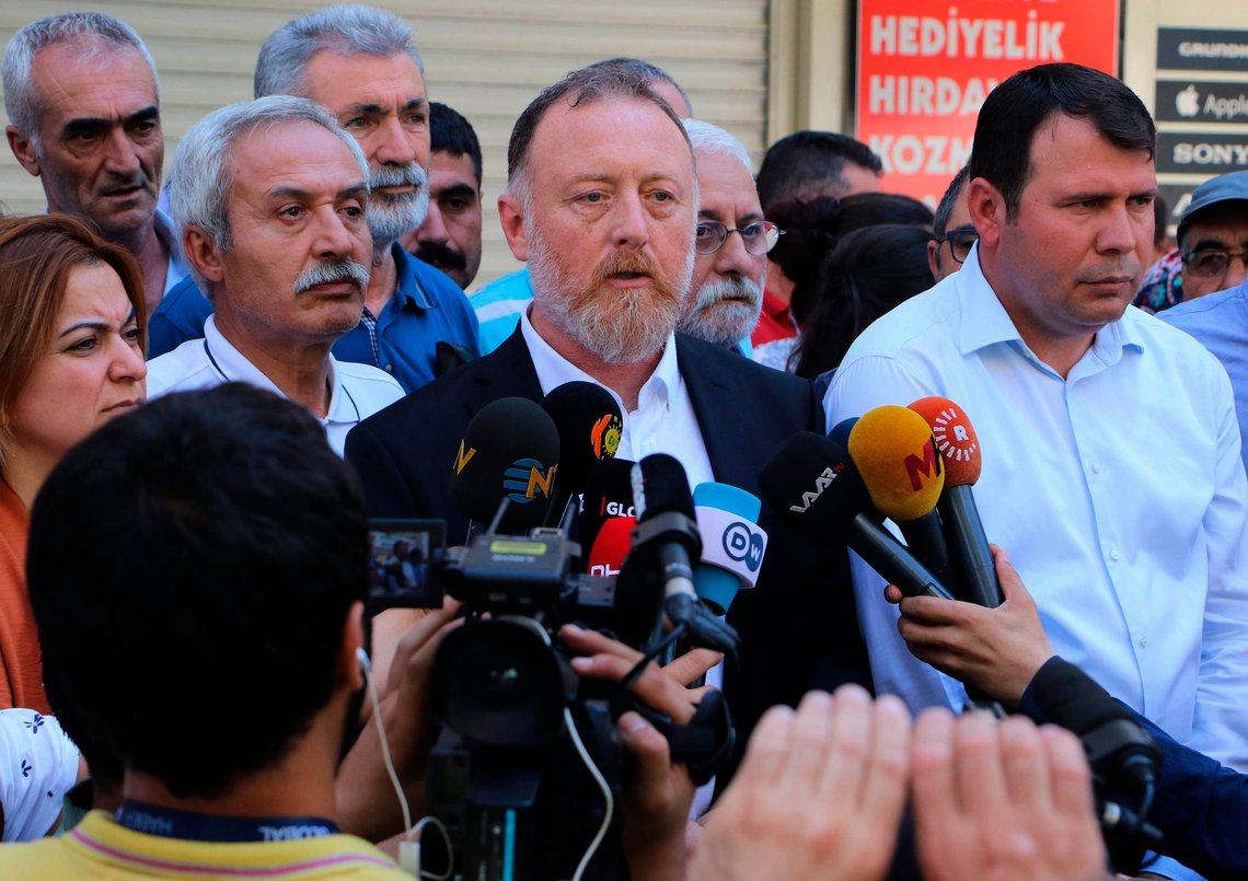 Sezai Temelli, co-chairman of pro- Kurdish Peoples' Democratic Party, or HDP, speaks to the media in Diyarbakir, Turkey, Tuesday, Aug. 20, 2019, a day after the mayors of the cities of Diyarbakir, Mardin and Van _ members HDP _ were sacked over alleged links to the Kurdistan Workers' Party, or PKK. In a new government crackdown on a pro-Kurdish party, Turkey on Monday removed from office the elected mayors, replacing them with government appointees. (AP Photo) Sezai Temelli, co-chairman of pro- Kurdish Peoples' Democratic Party, or HDP, speaks to the media in Diyarbakir, Turkey, Tuesday, Aug. 20, 2019, a day after the mayors of the cities of Diyarbakir, Mardin and Van _ members HDP _ were sacked over alleged links to the Kurdistan Workers' Party, or PKK. In a new government crackdown on a pro-Kurdish party, Turkey on Monday removed from office the elected mayors, replacing them with government appointees. (AP Photo)