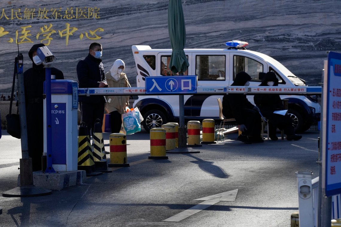 Security personnel guard an entrance to a hospital in Beijing, Saturday, Dec. 10, 2022. A rash of COVID-19 cases in schools and businesses were reported Friday in areas across China after the ruling Communist Party loosened anti-virus rules as it tries to reverse a deepening economic slump. (AP Photo/Ng Han Guan) Security personnel guard an entrance to a hospital in Beijing, Saturday, Dec. 10, 2022. A rash of COVID-19 cases in schools and businesses were reported Friday in areas across China after the ruling Communist Party loosened anti-virus rules as it tries to reverse a deepening economic slump. (AP Photo/Ng Han Guan)