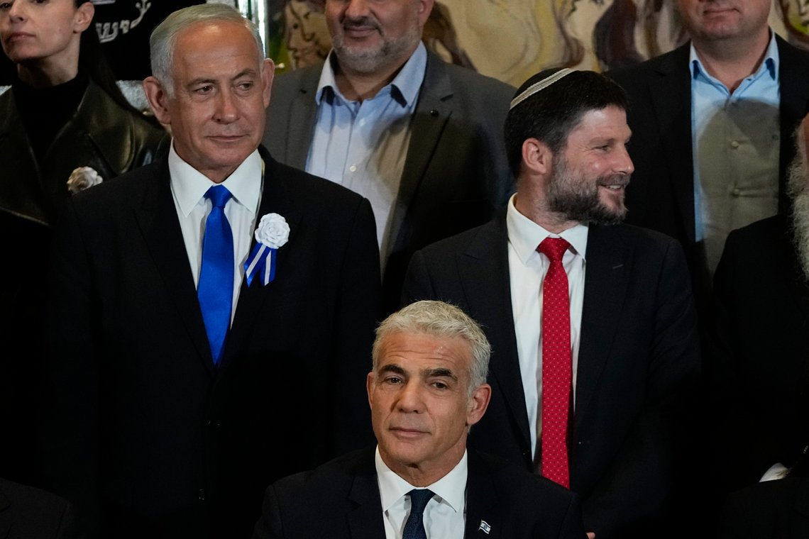Israeli Prime Minister Yair Lapid, center, Likud Party leader Benjamin Netanyahu, left, far-right Israeli lawmaker Bezalel Smotrich and leaders of all Israel's political parties pose for a group photo after the swearing-in ceremony for Israeli lawmakers at the Knesset, Israel's parliament, in Jerusalem, Tuesday, Nov. 15, 2022. Israeli lawmakers were sworn in at the Knesset, on Tuesday, following national elections earlier this month. (AP Photo/Tsafrir Abayov) Israeli Prime Minister Yair Lapid, center, Likud Party leader Benjamin Netanyahu, left, far-right Israeli lawmaker Bezalel Smotrich and leaders of all Israel's political parties pose for a group photo after the swearing-in ceremony for Israeli lawmakers at the Knesset, Israel's parliament, in Jerusalem, Tuesday, Nov. 15, 2022. Israeli lawmakers were sworn in at the Knesset, on Tuesday, following national elections earlier this month. (AP Photo/Tsafrir Abayov)