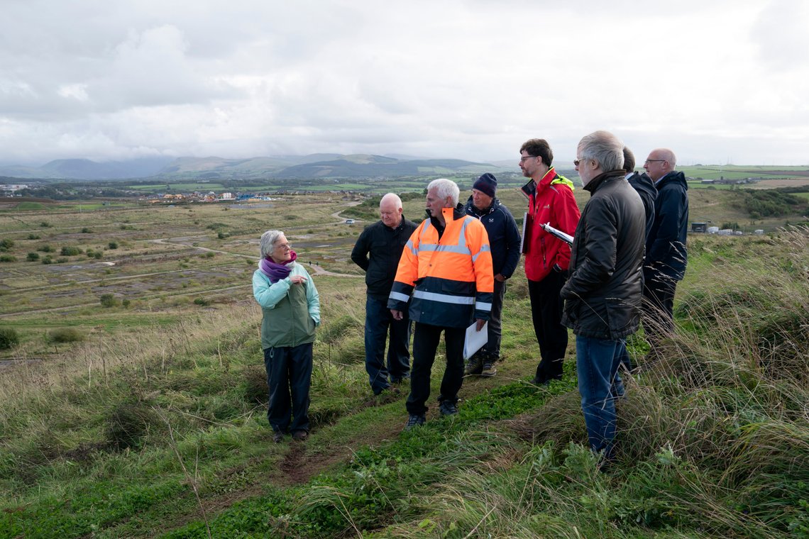 Maggie Mason of South Lakes Action on Climate Change, left, stands with members of a public inquiry into the feasibility of a proposed new coal mine during a visit to the site near the Cumbrian town of Whitehaven in northwest England, Monday, Oct. 4, 2021. Environmentalists are opposed to the idea of the new mine. "It's blindingly obvious that the quickest way to stop these carbon emissions and to make radical changes — which we have to do in the next 10 years — is to stop opening any new coal mines," said Maggie Mason, a local opponent of the mine. "The same is true for oil wells and gas wells." (AP Photo/Jon Super) Maggie Mason of South Lakes Action on Climate Change, left, stands with members of a public inquiry into the feasibility of a proposed new coal mine during a visit to the site near the Cumbrian town of Whitehaven in northwest England, Monday, Oct. 4, 2021. Environmentalists are opposed to the idea of the new mine. "It's blindingly obvious that the quickest way to stop these carbon emissions and to make radical changes — which we have to do in the next 10 years — is to stop opening any new coal mines," said Maggie Mason, a local opponent of the mine. "The same is true for oil wells and gas wells." (AP Photo/Jon Super)
