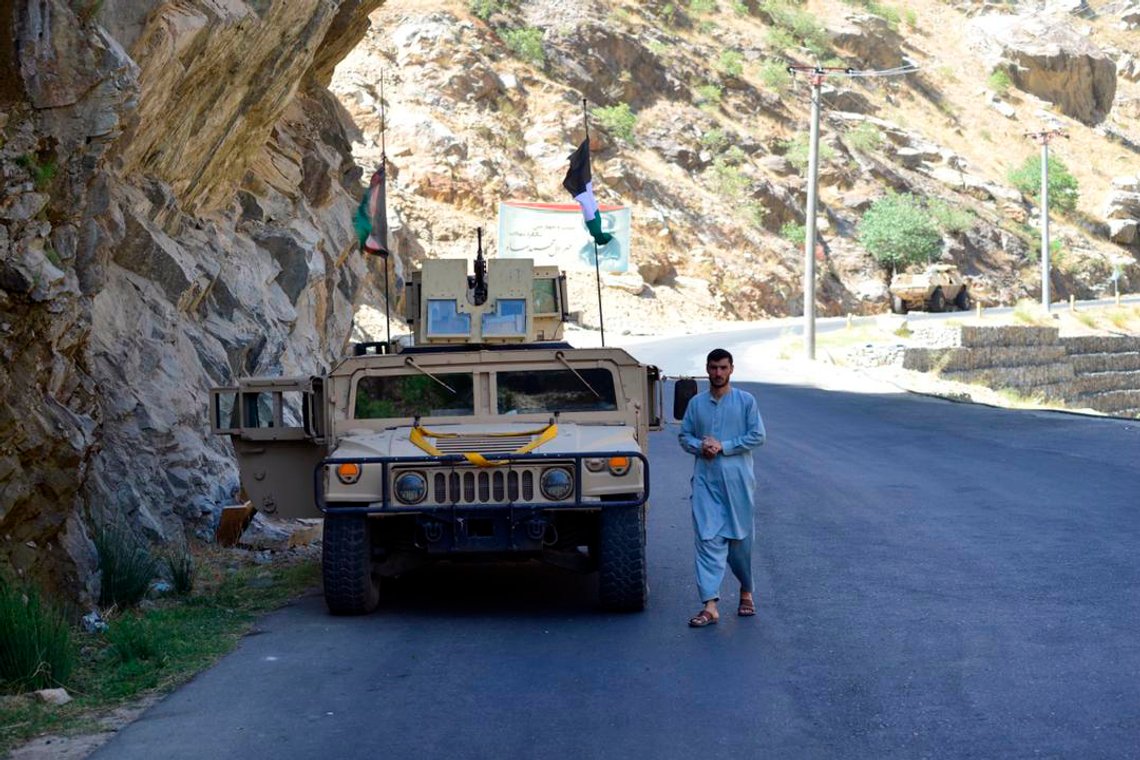 Militiaman loyal to Ahmad Massoud, son of Ahmad Shah Massoud, walks by a Humvee in Panjshir Valley, north of Kabul, Afghanistan, Wednesday, 25. 15, 2021. The Panjshir Valley is the last region not under Taliban control following their stunning blitz across Afghanistan. Local fighters held off the Soviets in the 1980s and the Taliban a decade later under the leadership of Ahmad Shah Massoud, a guerrilla fighter who attained near-mythic status before he was killed in a suicide bombing. (AP Photo/Jalaluddin Sekandar) Militiaman loyal to Ahmad Massoud, son of Ahmad Shah Massoud, walks by a Humvee in Panjshir Valley, north of Kabul, Afghanistan, Wednesday, 25. 15, 2021. The Panjshir Valley is the last region not under Taliban control following their stunning blitz across Afghanistan. Local fighters held off the Soviets in the 1980s and the Taliban a decade later under the leadership of Ahmad Shah Massoud, a guerrilla fighter who attained near-mythic status before he was killed in a suicide bombing. (AP Photo/Jalaluddin Sekandar)