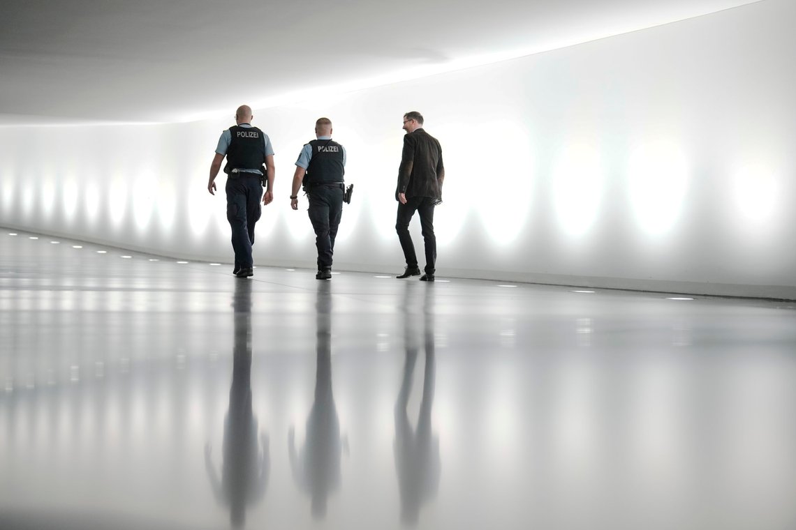 Police officers walk through a tunnel between the Reichstag building and a parliament office building in Berlin, Germany, Monday, Dec. 12, 2022. German lawmakers met Monday in a secure room at the basement within Parliament for a briefing by intelligence officials on the alleged coup plot by far-right extremists that authorities uncovered last week. Prosecutors say some of those detained last week had plans to enter the German parliament, or Bundestag, with weapons. (AP Photo/Markus Schreiber) Police officers walk through a tunnel between the Reichstag building and a parliament office building in Berlin, Germany, Monday, Dec. 12, 2022. German lawmakers met Monday in a secure room at the basement within Parliament for a briefing by intelligence officials on the alleged coup plot by far-right extremists that authorities uncovered last week. Prosecutors say some of those detained last week had plans to enter the German parliament, or Bundestag, with weapons. (AP Photo/Markus Schreiber)