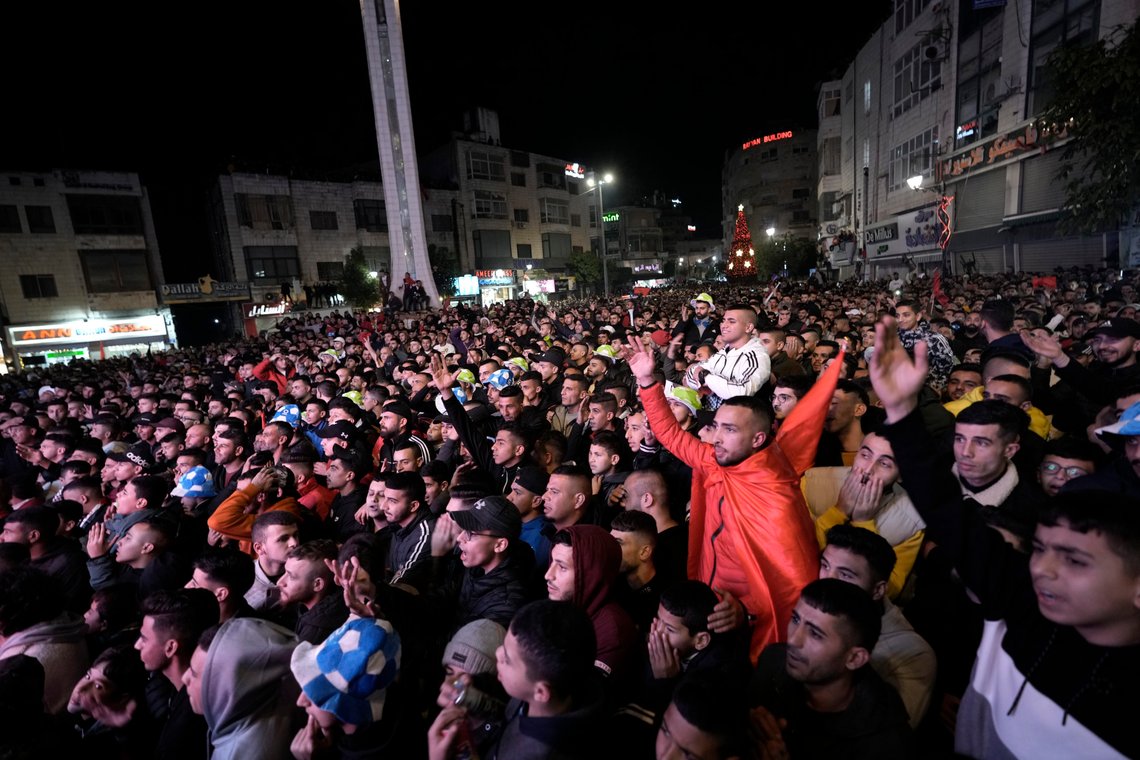 Palestinians watch a live broadcast of the World Cup semifinal soccer match between Morocco and France played in Qatar, in the West Bank city of Ramallah, Wednesday, Dec. 14, 2022. (AP Photo/ Majdi Mohammed) Palestinians watch a live broadcast of the World Cup semifinal soccer match between Morocco and France played in Qatar, in the West Bank city of Ramallah, Wednesday, Dec. 14, 2022. (AP Photo/ Majdi Mohammed)