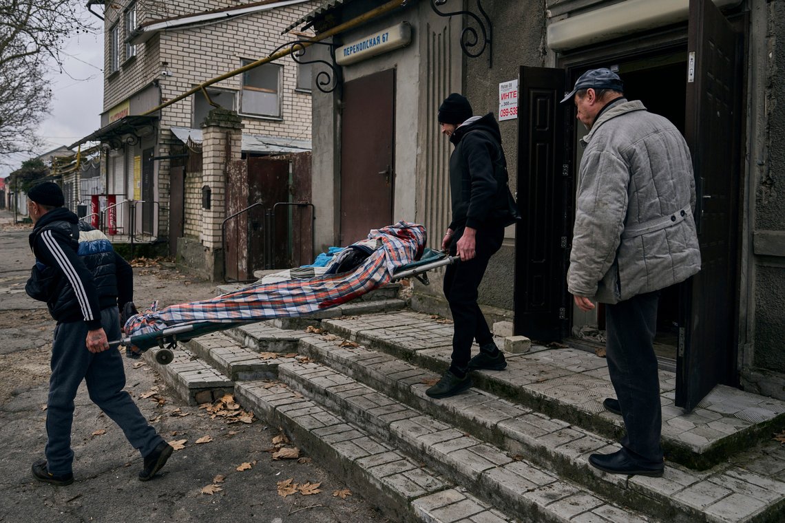 Local residents carry the body of a 20-year-old man killed in Russian shelling in Kherson, Ukraine, Thursday, Jan. 5, 2023. (AP Photo/LIBKOS) Local residents carry the body of a 20-year-old man killed in Russian shelling in Kherson, Ukraine, Thursday, Jan. 5, 2023. (AP Photo/LIBKOS)