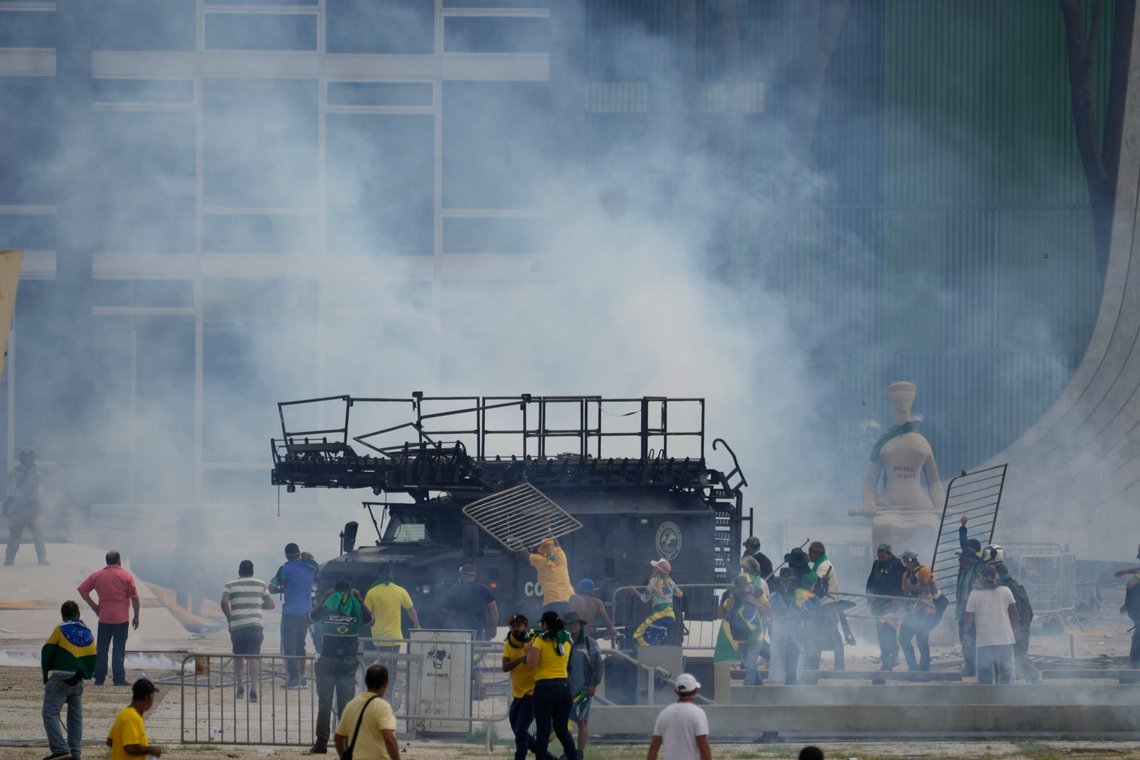 Protesters, supporters of Brazil's former President Jair Bolsonaro, attack a police armored vehicle after they stormed the Planalto Palace in Brasilia, Brazil, Sunday, Jan. 8, 2023. Planalto is the official workplace of the president of Brazil. (AP Photo/Eraldo Peres) Protesters, supporters of Brazil's former President Jair Bolsonaro, attack a police armored vehicle after they stormed the Planalto Palace in Brasilia, Brazil, Sunday, Jan. 8, 2023. Planalto is the official workplace of the president of Brazil. (AP Photo/Eraldo Peres)