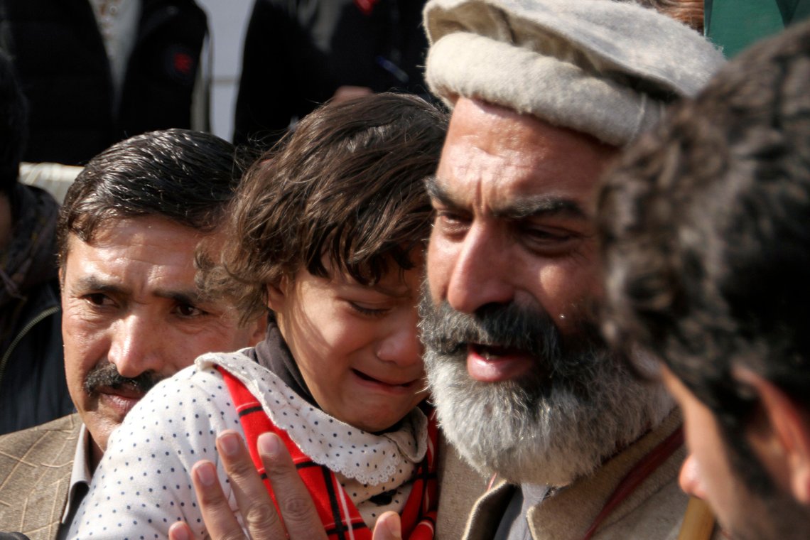 Family members of the victims of Monday's suicide bombing weep as they take part in a march denouncing militant attacks and demanding peace in the country in Peshawar, Pakistan, Wednesday, Feb. 1, 2023. The placard is center in Urdu language reading as 'Why is the blood of KP police so cheap?'. (AP Photo/Muhammad Sajjad) Family members of the victims of Monday's suicide bombing weep as they take part in a march denouncing militant attacks and demanding peace in the country in Peshawar, Pakistan, Wednesday, Feb. 1, 2023. The placard is center in Urdu language reading as 'Why is the blood of KP police so cheap?'. (AP Photo/Muhammad Sajjad)