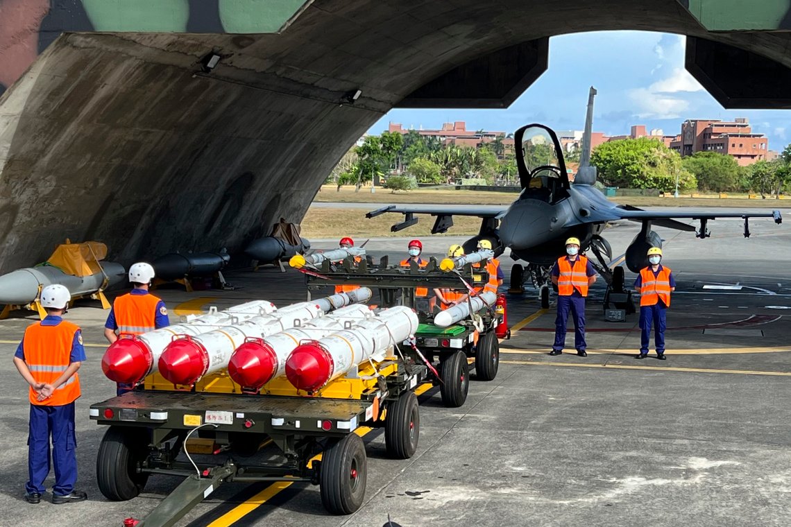 Military personnel stand next to U.S. Harpoon A-84, anti-ship missiles and AIM-120 and AIM-9 air-to-air missiles prepared for a weapon loading drills in front of a U.S. F-16V fighter jet at the Hualien Airbase in Taiwan's southeastern Hualien county, Wednesday, Aug. 17, 2022. China announced sanctions on Friday, Sept. 16, 2022, against the CEOs of American defense contractors Raytheon and Boeing Defense over a major U.S. arms sale to rival Taiwan. (AP Photo/Johnson Lai, File) Military personnel stand next to U.S. Harpoon A-84, anti-ship missiles and AIM-120 and AIM-9 air-to-air missiles prepared for a weapon loading drills in front of a U.S. F-16V fighter jet at the Hualien Airbase in Taiwan's southeastern Hualien county, Wednesday, Aug. 17, 2022. China announced sanctions on Friday, Sept. 16, 2022, against the CEOs of American defense contractors Raytheon and Boeing Defense over a major U.S. arms sale to rival Taiwan. (AP Photo/Johnson Lai, File)