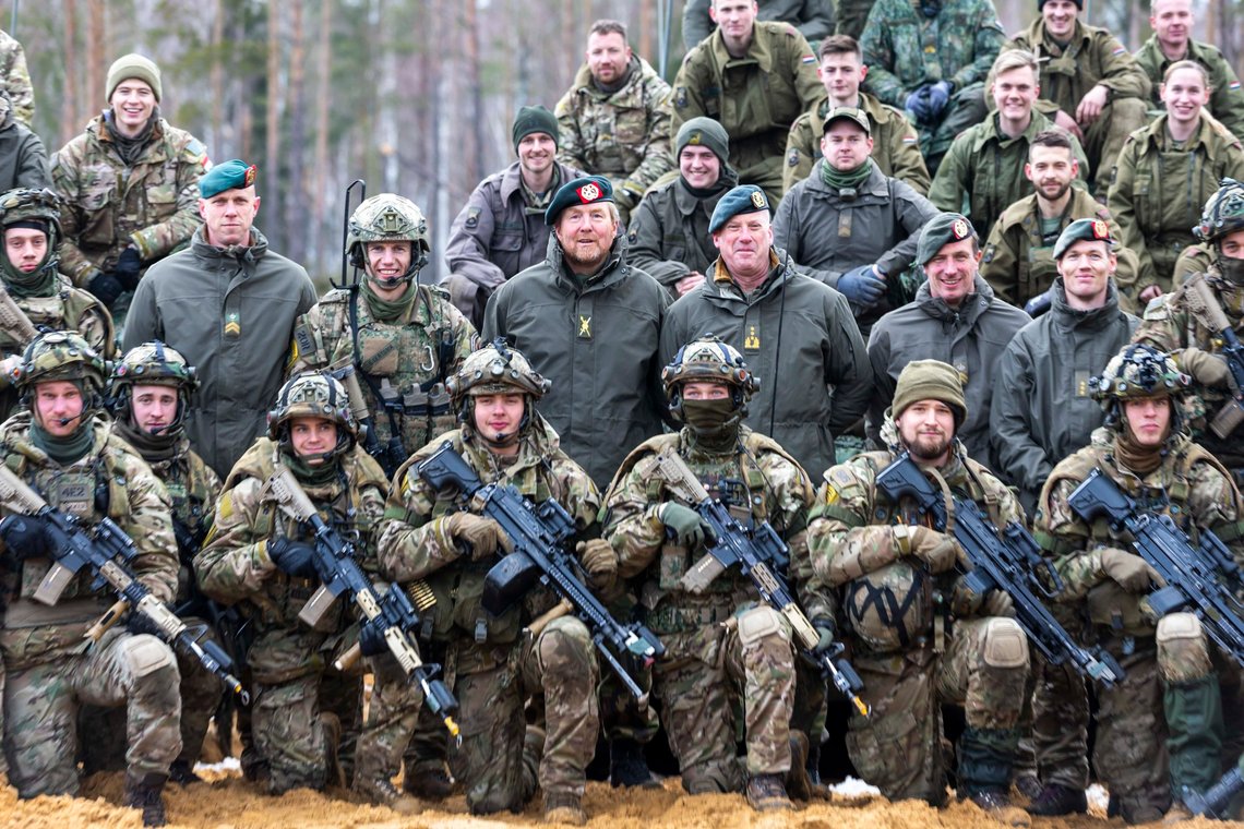 In this photo provided by Lithuanian Ministry of National Defense, Dutch King Willem-Alexander, center, poses for photographers with Netherlands' soldiers of the NATO enhanced forward presence battalion during their visit to the Training Range in Pabrade, some 60km (38 miles) north of the capital Vilnius, Lithuania, Tuesday, Feb. 21, 2023. (Lithuanian Ministry of National Defense via AP) In this photo provided by Lithuanian Ministry of National Defense, Dutch King Willem-Alexander, center, poses for photographers with Netherlands' soldiers of the NATO enhanced forward presence battalion during their visit to the Training Range in Pabrade, some 60km (38 miles) north of the capital Vilnius, Lithuania, Tuesday, Feb. 21, 2023. (Lithuanian Ministry of National Defense via AP)