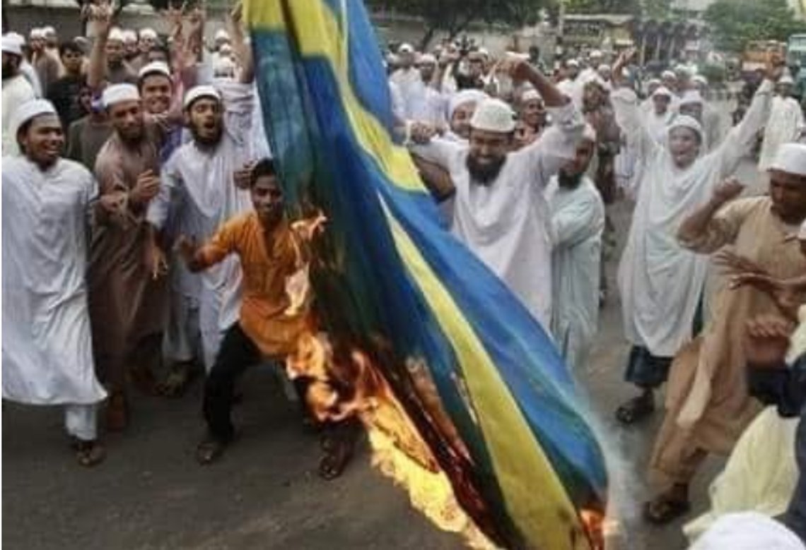 Folk brenner det svenske flagget i Bangladesh. Svensk politi føyer seg for voldspøbelen. Skjermdump Twitter Folk brenner det svenske flagget i Bangladesh. Svensk politi føyer seg for voldspøbelen. Skjermdump Twitter