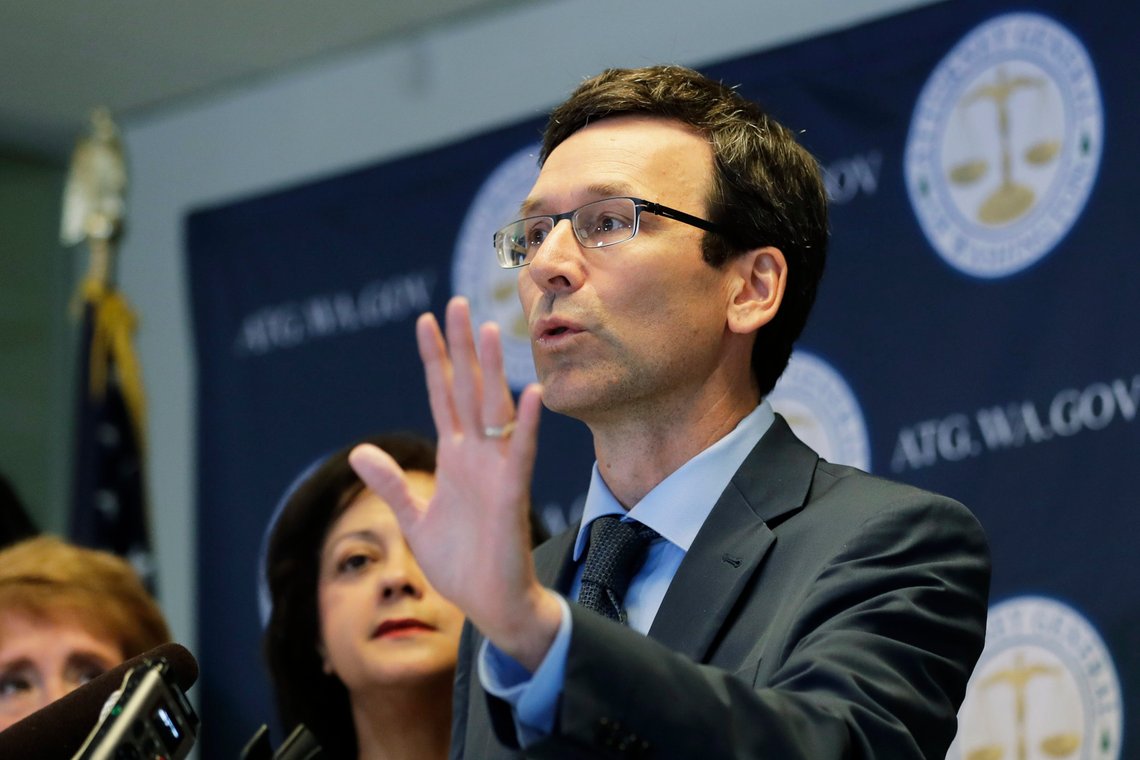 FILE - Washington Attorney General Bob Ferguson talks to reporters, Monday, Aug. 26, 2019, during a news conference in Seattle. A trade group that represents some of the biggest U.S. food companies has agreed to pay $9 million for violations of Washington campaign finance laws, after the state Supreme Court upheld a penalty twice that much. Ferguson, who sued the group in 2013, announced it was dropping its appeal and would instead settle the case for $9 million, including $3 million in donations to two charities that fight hunger. (AP Photo/Ted S. Warren,File) FILE - Washington Attorney General Bob Ferguson talks to reporters, Monday, Aug. 26, 2019, during a news conference in Seattle. A trade group that represents some of the biggest U.S. food companies has agreed to pay $9 million for violations of Washington campaign finance laws, after the state Supreme Court upheld a penalty twice that much. Ferguson, who sued the group in 2013, announced it was dropping its appeal and would instead settle the case for $9 million, including $3 million in donations to two charities that fight hunger. (AP Photo/Ted S. Warren,File)
