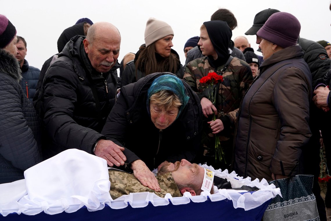 A mother mourns over the coffin of her son, Eugeny Shmatko, a soldier killed in a battle with the Russian troops, during a funeral ceremony in a city cemetery in Kharkiv, Ukraine, Tuesday, March 21, 2023. (AP Photo/Andrii Marienko) A mother mourns over the coffin of her son, Eugeny Shmatko, a soldier killed in a battle with the Russian troops, during a funeral ceremony in a city cemetery in Kharkiv, Ukraine, Tuesday, March 21, 2023. (AP Photo/Andrii Marienko)