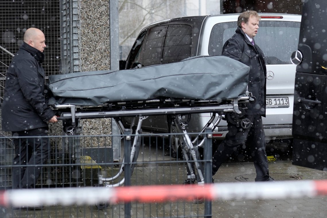 Corpses are carried out of a Jehovah's Witness building in Hamburg, Germany Friday, March 10, 2023. Shots were fired inside the building used by Jehovah's Witnesses in the northern German city of Hamburg on Thursday evening, with multiple people killed and wounded, police said. (AP Photo/Markus Schreiber) Corpses are carried out of a Jehovah's Witness building in Hamburg, Germany Friday, March 10, 2023. Shots were fired inside the building used by Jehovah's Witnesses in the northern German city of Hamburg on Thursday evening, with multiple people killed and wounded, police said. (AP Photo/Markus Schreiber)