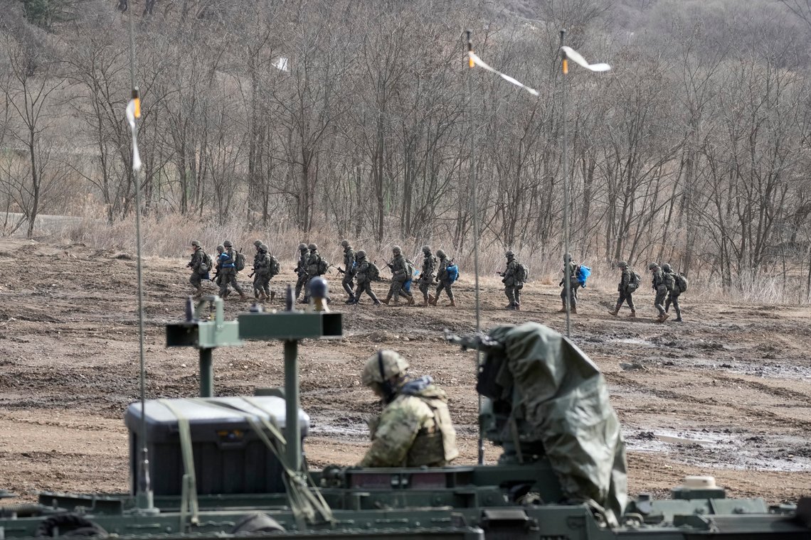 South Korean soldiers march as A U.S. soldier sits on military vehicle during their joint military drill in Paju, South Korea, Thursday, March 16, 2023. North Korea test-launched an intercontinental ballistic missile Thursday just hours before the leaders of South Korea and Japan were to meet at a Tokyo summit expected to be overshadowed by North Korean nuclear threats. The North's first ICBM test in a month and third weapons tests this week also comes as South Korean and U.S. troops continue joint military exercises that Pyongyang considers a rehearsal to invade. (AP Photo/Lee Jin-man) South Korean soldiers march as A U.S. soldier sits on military vehicle during their joint military drill in Paju, South Korea, Thursday, March 16, 2023. North Korea test-launched an intercontinental ballistic missile Thursday just hours before the leaders of South Korea and Japan were to meet at a Tokyo summit expected to be overshadowed by North Korean nuclear threats. The North's first ICBM test in a month and third weapons tests this week also comes as South Korean and U.S. troops continue joint military exercises that Pyongyang considers a rehearsal to invade. (AP Photo/Lee Jin-man)