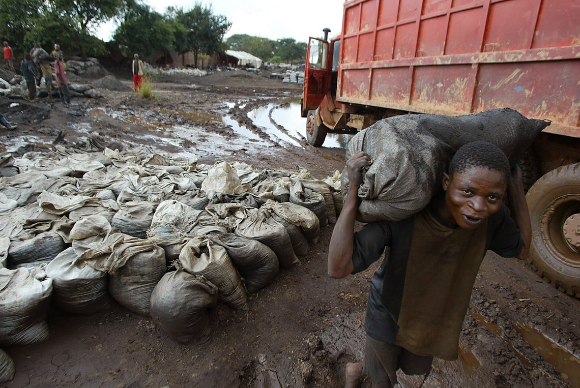 ** FILE ** A young man carries wet Cobalt on his back at the Shinkolobwe mine 35kms from the town of Likasi, Democratic Republic of Congo, in this Saturday, April 10, 2004 file photo. Massive illicit digging at the uranium mine that fueled the Nagasaki and Hiroshima bombs threatens to put the mine's nuclear ore into terrorist hands, U.N. investigators warned. Cobalt is the main mineral mined in the area. (AP Photo/Schalk van Zuydam, File) ** FILE ** A young man carries wet Cobalt on his back at the Shinkolobwe mine 35kms from the town of Likasi, Democratic Republic of Congo, in this Saturday, April 10, 2004 file photo. Massive illicit digging at the uranium mine that fueled the Nagasaki and Hiroshima bombs threatens to put the mine's nuclear ore into terrorist hands, U.N. investigators warned. Cobalt is the main mineral mined in the area. (AP Photo/Schalk van Zuydam, File)