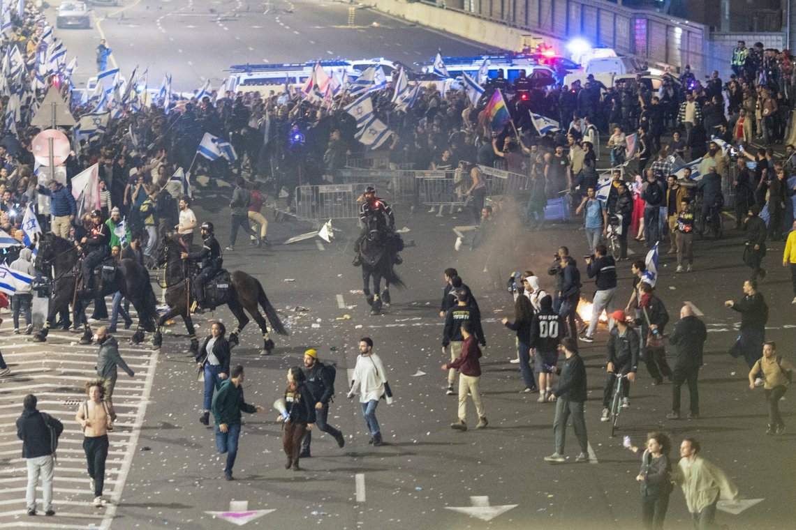 Israeli police disperse demonstrators blocking a highway during a protest against plans by Prime Minister Benjamin Netanyahu's government to overhaul the judicial system in Tel Aviv, Israel, Monday, March 27, 2023. Tens of thousands of Israelis have poured into the streets across the country in a spontaneous outburst of anger after Prime Minister Benjamin Netanyahu abruptly fired his defense minister for challenging the Israeli leader's judicial overhaul plan. (AP Photo/Oren Ziv) Israeli police disperse demonstrators blocking a highway during a protest against plans by Prime Minister Benjamin Netanyahu's government to overhaul the judicial system in Tel Aviv, Israel, Monday, March 27, 2023. Tens of thousands of Israelis have poured into the streets across the country in a spontaneous outburst of anger after Prime Minister Benjamin Netanyahu abruptly fired his defense minister for challenging the Israeli leader's judicial overhaul plan. (AP Photo/Oren Ziv)