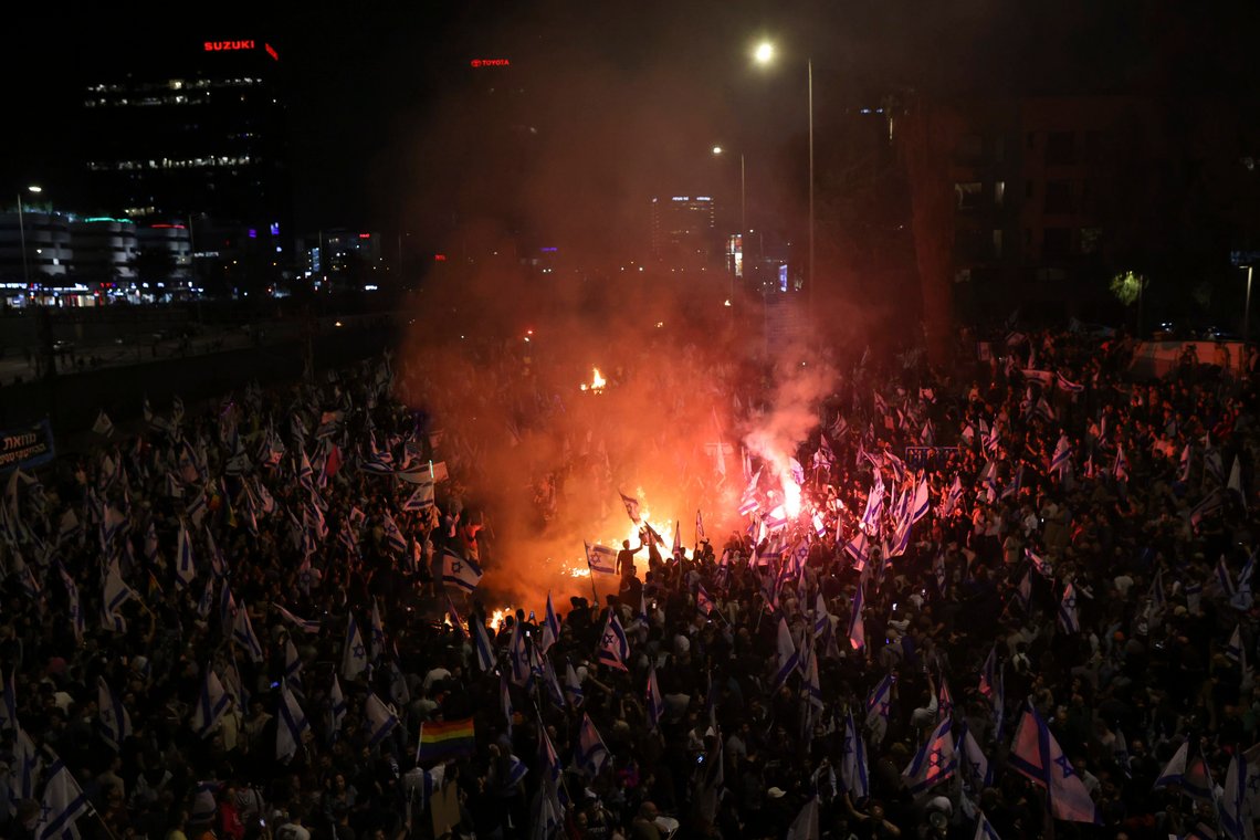 Israelis opposed to Prime Minister Benjamin Netanyahu's judicial overhaul plan set up bonfires and block a highway during a protest moments after the Israeli leader fired his defense minister, in Tel Aviv, Israel, Sunday, March 26, 2023. Defense Minister Yoav Gallant had called on Netanyahu to freeze the plan, citing deep divisions in the country and turmoil in the military. (AP Photo/Oren Ziv) Israelis opposed to Prime Minister Benjamin Netanyahu's judicial overhaul plan set up bonfires and block a highway during a protest moments after the Israeli leader fired his defense minister, in Tel Aviv, Israel, Sunday, March 26, 2023. Defense Minister Yoav Gallant had called on Netanyahu to freeze the plan, citing deep divisions in the country and turmoil in the military. (AP Photo/Oren Ziv)