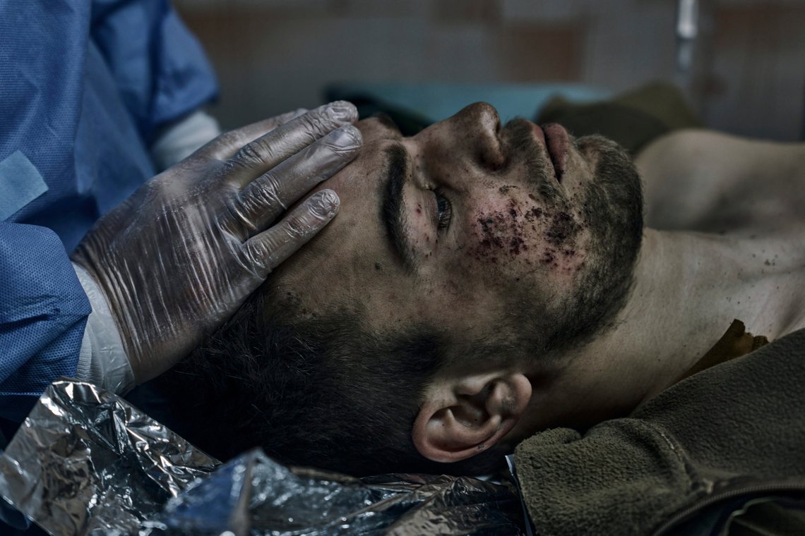 Military medics give first aid to a soldier wounded in a battle in Bakhmut, Donetsk region, Ukraine, Sunday, April 9, 2023. (AP Photo/Libkos) Military medics give first aid to a soldier wounded in a battle in Bakhmut, Donetsk region, Ukraine, Sunday, April 9, 2023. (AP Photo/Libkos)