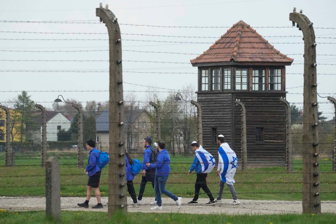 FILE - Jewish people visit the Auschwitz Nazi concentration camp after the March of the Living annual observance, in Oswiecim, Poland, April 28, 2022. Israel’s national Holocaust memorial has criticized a new agreement renewing Israeli school trips to Poland, saying it recommends a number of “problematic sites” that distort history. (AP Photo/Czarek Sokolowski, File) FILE - Jewish people visit the Auschwitz Nazi concentration camp after the March of the Living annual observance, in Oswiecim, Poland, April 28, 2022. Israel’s national Holocaust memorial has criticized a new agreement renewing Israeli school trips to Poland, saying it recommends a number of “problematic sites” that distort history. (AP Photo/Czarek Sokolowski, File)