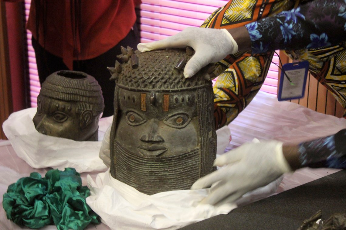 Benin bronzes looted in the past and returned to Nigeria are examined during a handing over ceremony in Abuja, Nigeria, Tuesday, Dec. 20, 2022. Germany returned 20 historic bronze sculptures to Nigeria as part of efforts to address what its foreign minister called its “dark colonial past.” Nigeria officials said that more than 5,000 ancient artifacts are estimated to have been stolen from Nigeria, the majority by England, the country’s former colonizer and some by Germany. (AP Photo/Olamikan Gbemiga) Benin bronzes looted in the past and returned to Nigeria are examined during a handing over ceremony in Abuja, Nigeria, Tuesday, Dec. 20, 2022. Germany returned 20 historic bronze sculptures to Nigeria as part of efforts to address what its foreign minister called its “dark colonial past.” Nigeria officials said that more than 5,000 ancient artifacts are estimated to have been stolen from Nigeria, the majority by England, the country’s former colonizer and some by Germany. (AP Photo/Olamikan Gbemiga)