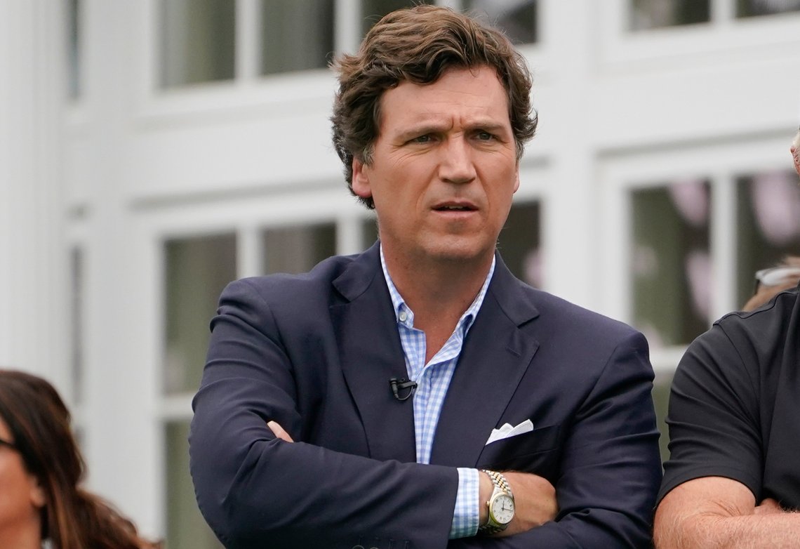 FILE - Tucker Carlson attends the final round of the Bedminster Invitational LIV Golf tournament in Bedminster, N.J., Sunday, July 31, 2022. Fox News says it has agreed to part ways with Tucker Carlson, less than a week after settling a lawsuit over the network’s 2020 election reporting. The network said in a press release Monday that the popular and controversial prime-time host's last program aired on Friday. (AP Photo/Seth Wenig, File) FILE - Tucker Carlson attends the final round of the Bedminster Invitational LIV Golf tournament in Bedminster, N.J., Sunday, July 31, 2022. Fox News says it has agreed to part ways with Tucker Carlson, less than a week after settling a lawsuit over the network’s 2020 election reporting. The network said in a press release Monday that the popular and controversial prime-time host's last program aired on Friday. (AP Photo/Seth Wenig, File)
