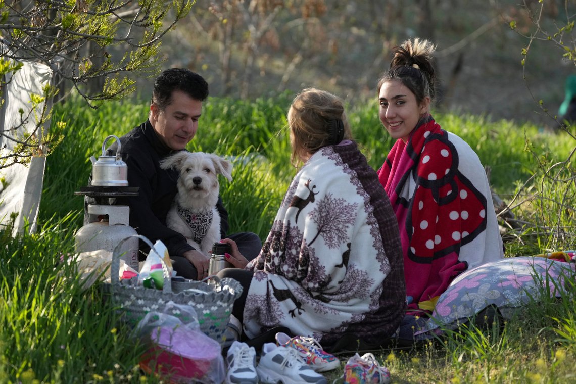 People enjoy their time at a park in Tehran, Iran, Sunday, April 2, 2023. Iranians flocked to parks and wilderness on their annual public picnic day, known as Sizdeh Bedar, as they enjoy the 13th and last day of Nowruz holidays, an ancient tradition dating back to pre-Islamic era that is still celebrated under the Islamic theocracy. (AP Photo/Vahid Salemi) People enjoy their time at a park in Tehran, Iran, Sunday, April 2, 2023. Iranians flocked to parks and wilderness on their annual public picnic day, known as Sizdeh Bedar, as they enjoy the 13th and last day of Nowruz holidays, an ancient tradition dating back to pre-Islamic era that is still celebrated under the Islamic theocracy. (AP Photo/Vahid Salemi)
