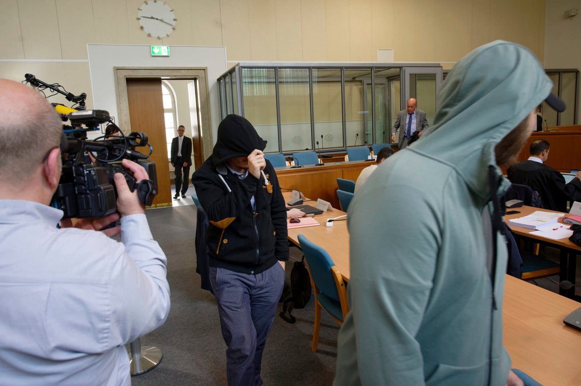 In this Friday, May 24, 2019 file photo, two defendants of a self-styled 'Sharia police' arrive in a courtroom in Wuppertal, Germany. The court has found seven men who posed as a self-styled 'Sharia police' in the country, guilty on charges they violated rules on wearing uniforms and fined the men to penalties between 300 (335 dollars) and 1,800 (2010 dollars) euros. (Henning Kaiser/dpa via AP) In this Friday, May 24, 2019 file photo, two defendants of a self-styled 'Sharia police' arrive in a courtroom in Wuppertal, Germany. The court has found seven men who posed as a self-styled 'Sharia police' in the country, guilty on charges they violated rules on wearing uniforms and fined the men to penalties between 300 (335 dollars) and 1,800 (2010 dollars) euros. (Henning Kaiser/dpa via AP)