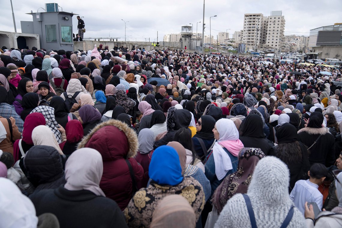 Palestinian women gather in front of the designated security checkpoint while they wait to be allowed to cross from the West Bank into Jerusalem, for the second Friday's Ramadan prayers at the Al Aqsa mosque compound, at the Qalandia Israeli army checkpoint, near Ramallah, Friday, March 31, 2023. (AP Photo/Nasser Nasser) Palestinian women gather in front of the designated security checkpoint while they wait to be allowed to cross from the West Bank into Jerusalem, for the second Friday's Ramadan prayers at the Al Aqsa mosque compound, at the Qalandia Israeli army checkpoint, near Ramallah, Friday, March 31, 2023. (AP Photo/Nasser Nasser)