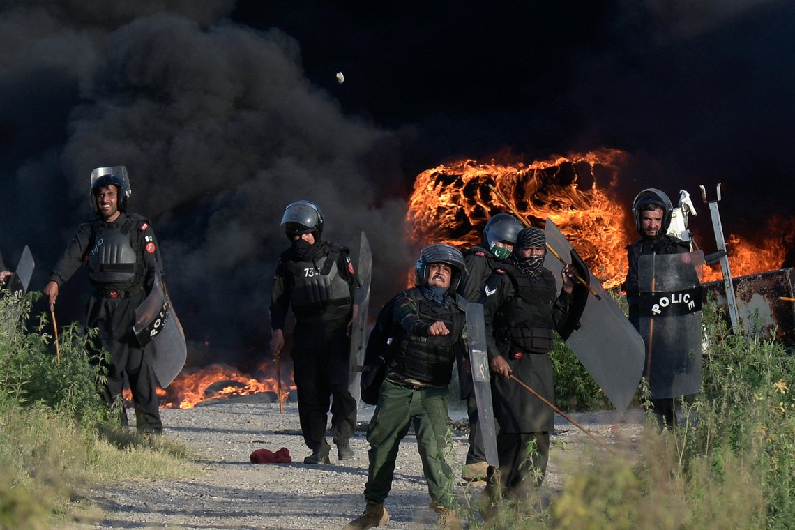 Police officers throw stones towards supporters of Pakistan's former Prime Minister Imran Khan during clashes, in Islamabad, Pakistan, Wednesday, May 10, 2023. Khan appeared in court Wednesday, a day after he was dragged from another court and arrested in Islamabad, and his supporters clashed with police across the country. A judge was asked to approve keeping the 70-year-old opposition leader in custody for up to 14 days. (AP Photo) Police officers throw stones towards supporters of Pakistan's former Prime Minister Imran Khan during clashes, in Islamabad, Pakistan, Wednesday, May 10, 2023. Khan appeared in court Wednesday, a day after he was dragged from another court and arrested in Islamabad, and his supporters clashed with police across the country. A judge was asked to approve keeping the 70-year-old opposition leader in custody for up to 14 days. (AP Photo)