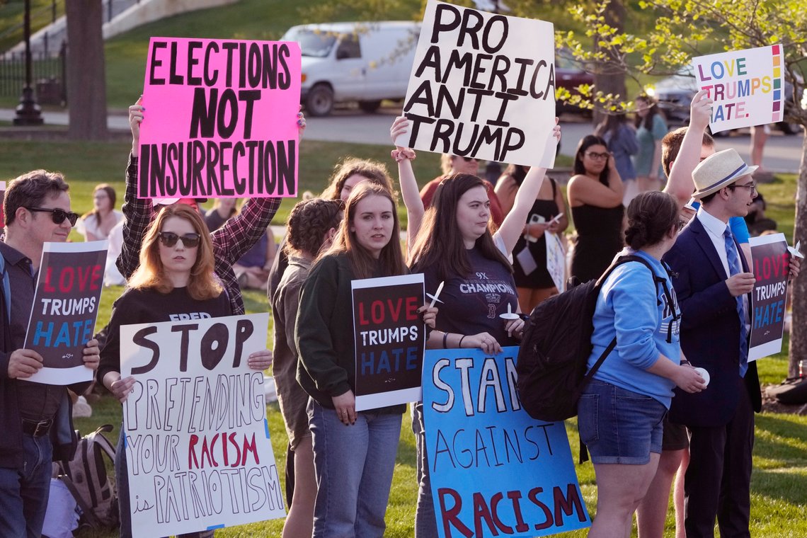 People protest outside a building on the campus of Saint Anselm College hosting a CNN televised town hall gathering with former President Donald Trump, Wednesday, May 10, 2023, in Manchester, N.H. (AP Photo/Charles Krupa) People protest outside a building on the campus of Saint Anselm College hosting a CNN televised town hall gathering with former President Donald Trump, Wednesday, May 10, 2023, in Manchester, N.H. (AP Photo/Charles Krupa)