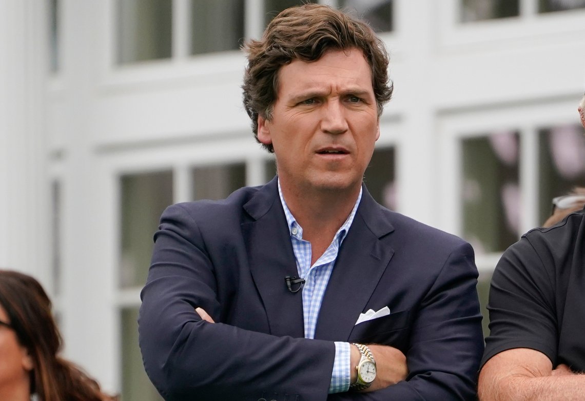 FILE - Tucker Carlson attends the final round of the Bedminster Invitational LIV Golf tournament in Bedminster, N.J., July 31, 2022. A racist text message from Tucker Carlson is what helped drive the commentator's ouster from Fox News, The New York Times reports. The Times says that in a text uncovered as part of a recent defamation lawsuit, the former Fox host lamented how supporters of former President Donald Trump ganged up to beat a protester. “It's not how white men fight,” Carlson wrote. (AP Photo/Seth Wenig, File) FILE - Tucker Carlson attends the final round of the Bedminster Invitational LIV Golf tournament in Bedminster, N.J., July 31, 2022. A racist text message from Tucker Carlson is what helped drive the commentator's ouster from Fox News, The New York Times reports. The Times says that in a text uncovered as part of a recent defamation lawsuit, the former Fox host lamented how supporters of former President Donald Trump ganged up to beat a protester. “It's not how white men fight,” Carlson wrote. (AP Photo/Seth Wenig, File)